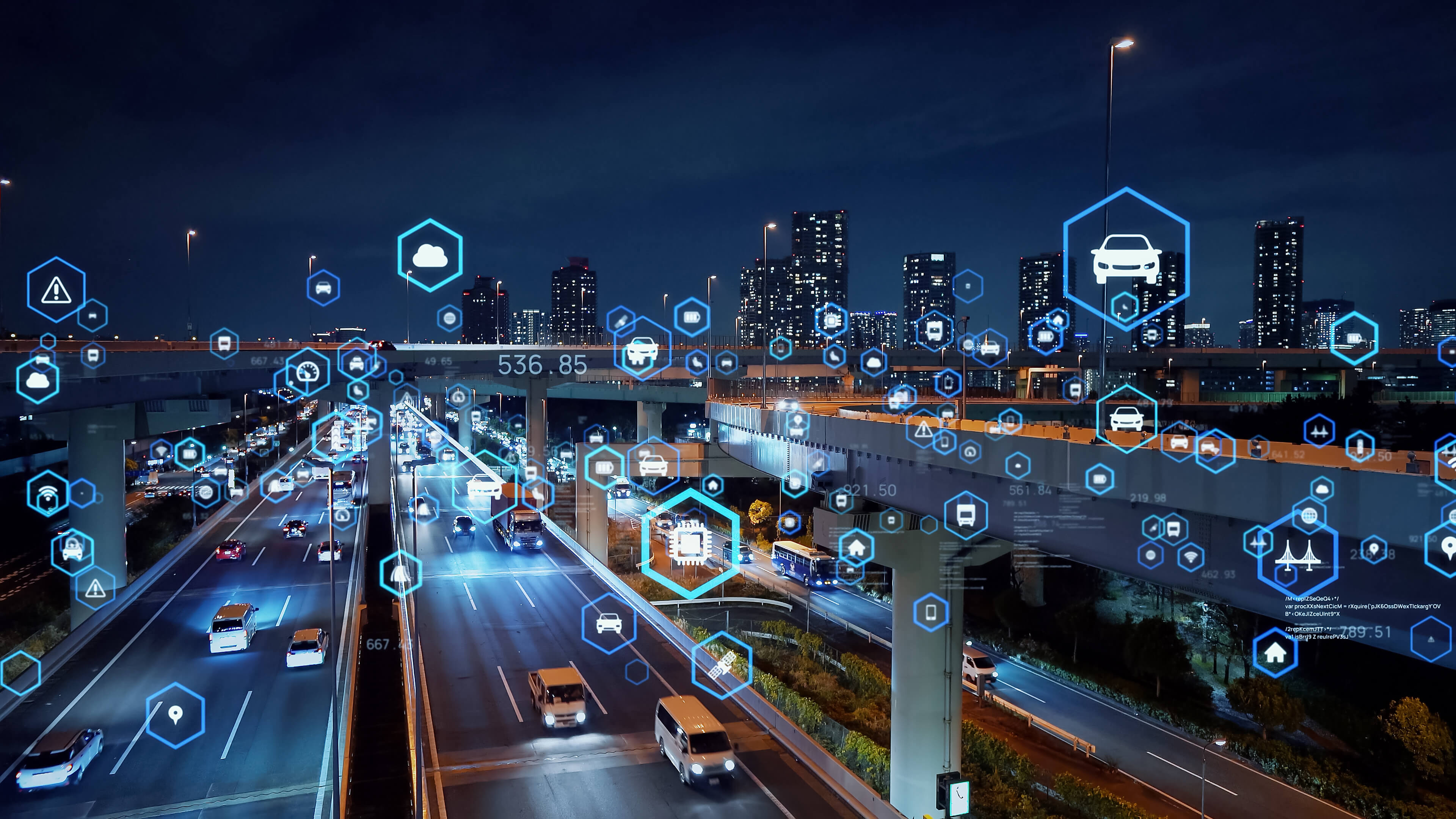 Nighttime cityscape with connected vehicle and data icons representing Kia’s FMS (Fleet Management System) integration