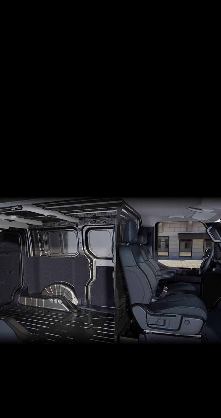 Side interior view of the Kia PV5 Cargo showing open cargo space and front seats