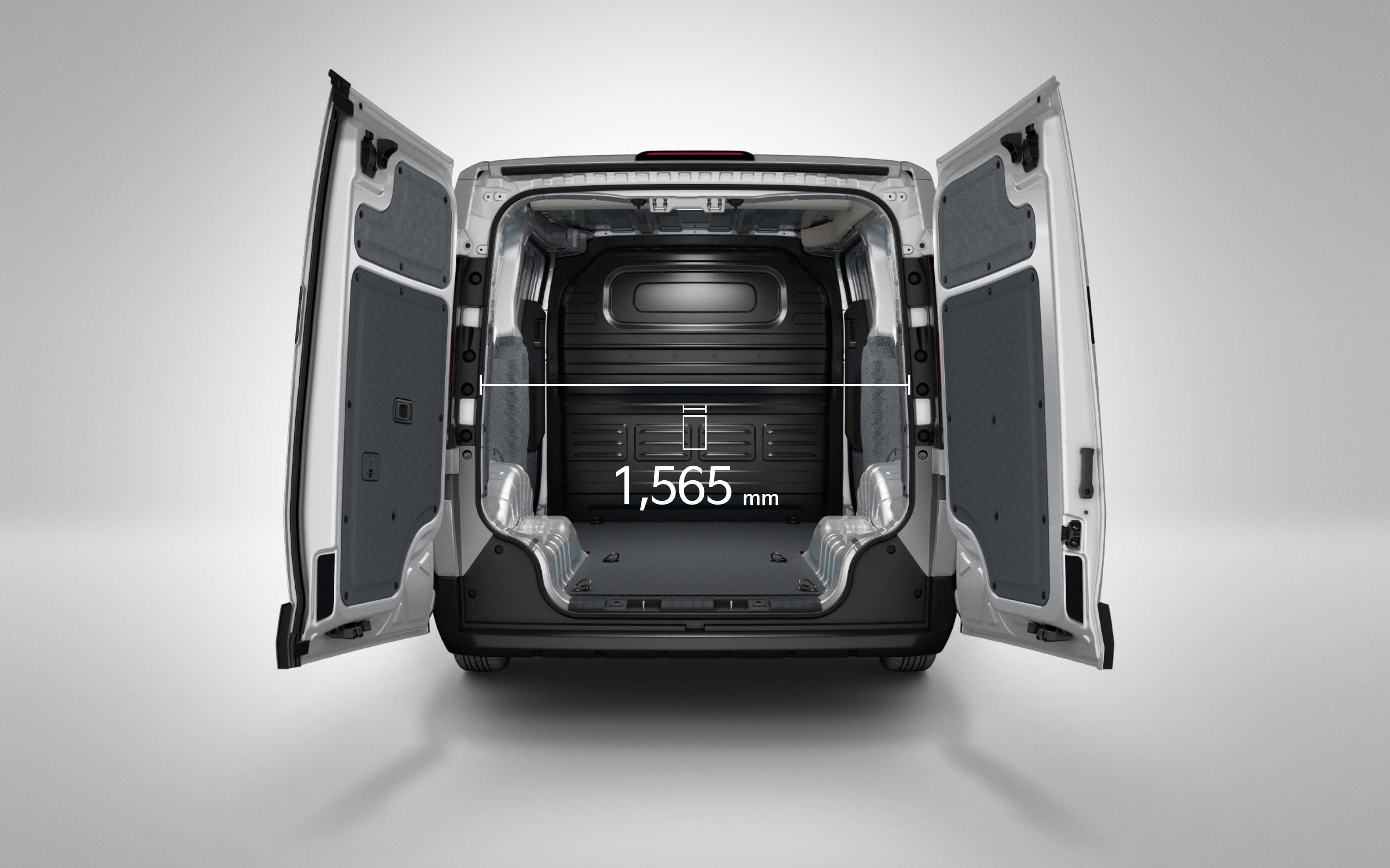Rear cargo view of the Kia PV5 Cargo showing interior width measurement of 1,565 mm