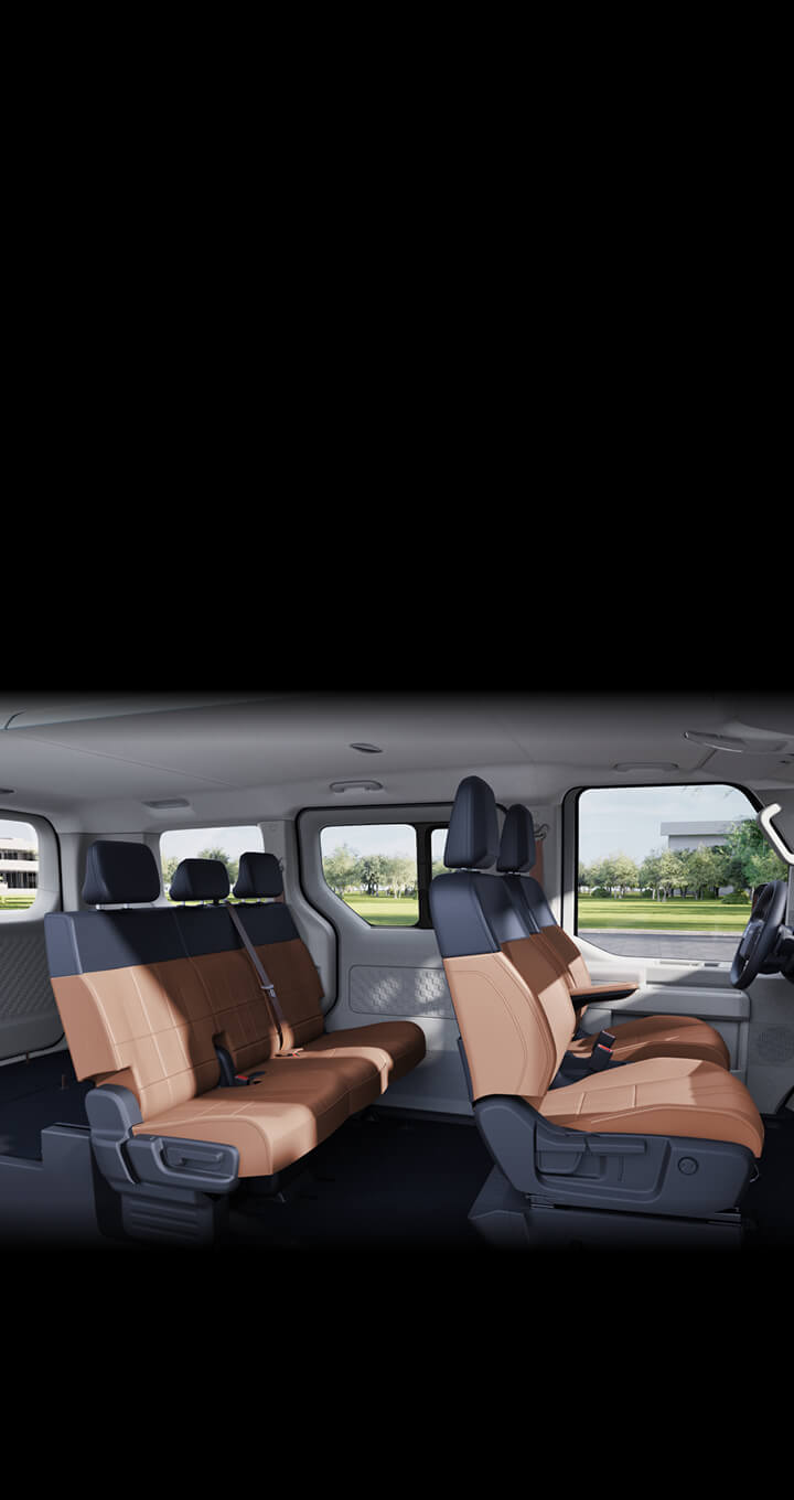 Rear interior of the Kia PV5 Passenger with heated second-row seats, swivel seating for better conversation, and lumbar support for long-distance comfort
