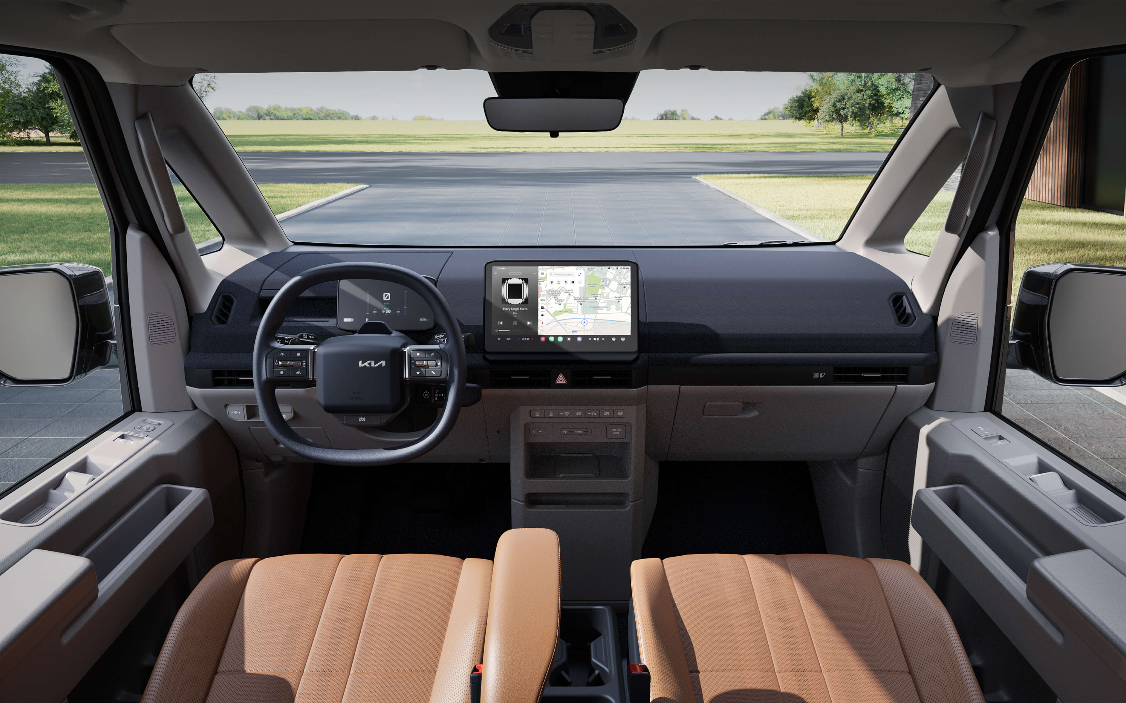 Front interior view of the Kia PV5 Passenger highlighting wide windshield visibility, heated steering wheel, and durable seat materials for daily use