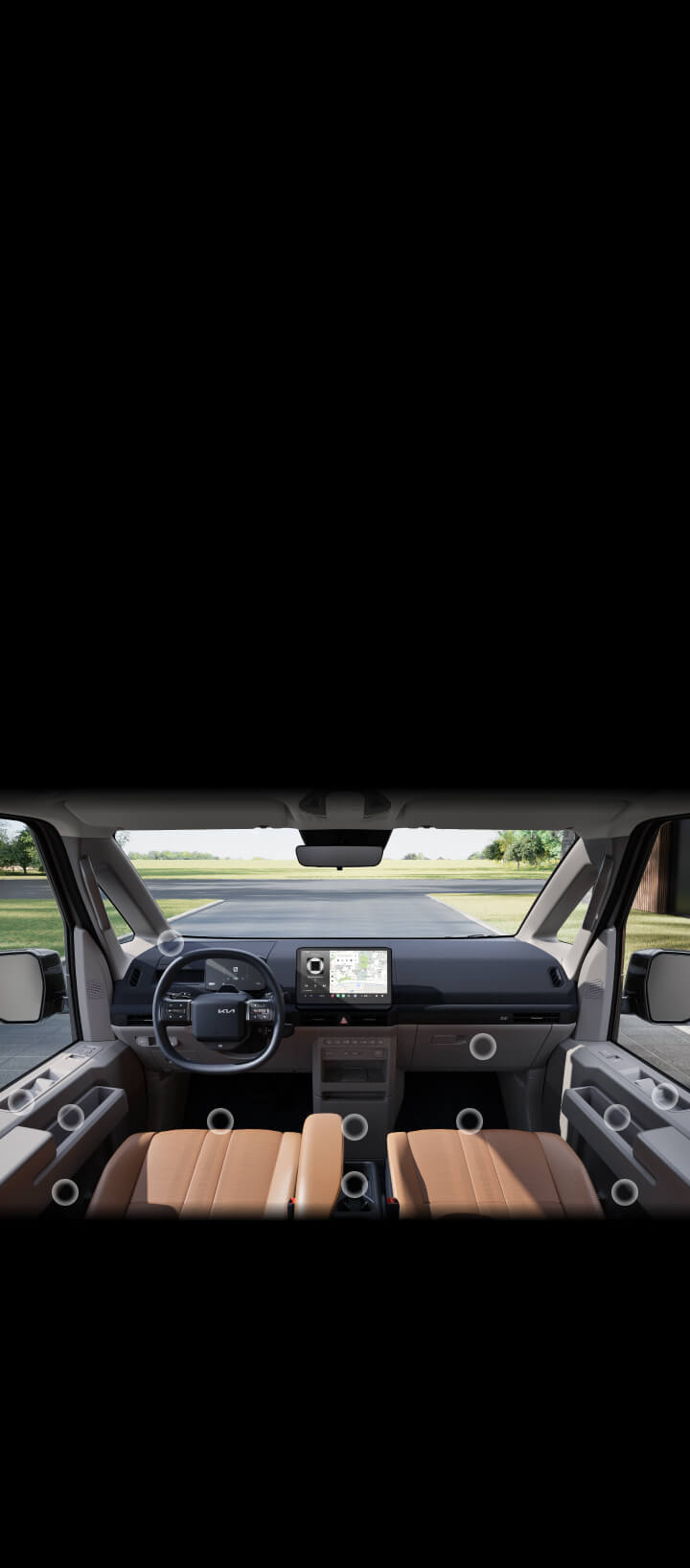 Front interior view of the Kia PV5 passenger highlighting multiple hidden storage compartments around the driver and passenger area