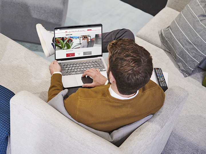 Man is holding a smartphone with the MyKia app