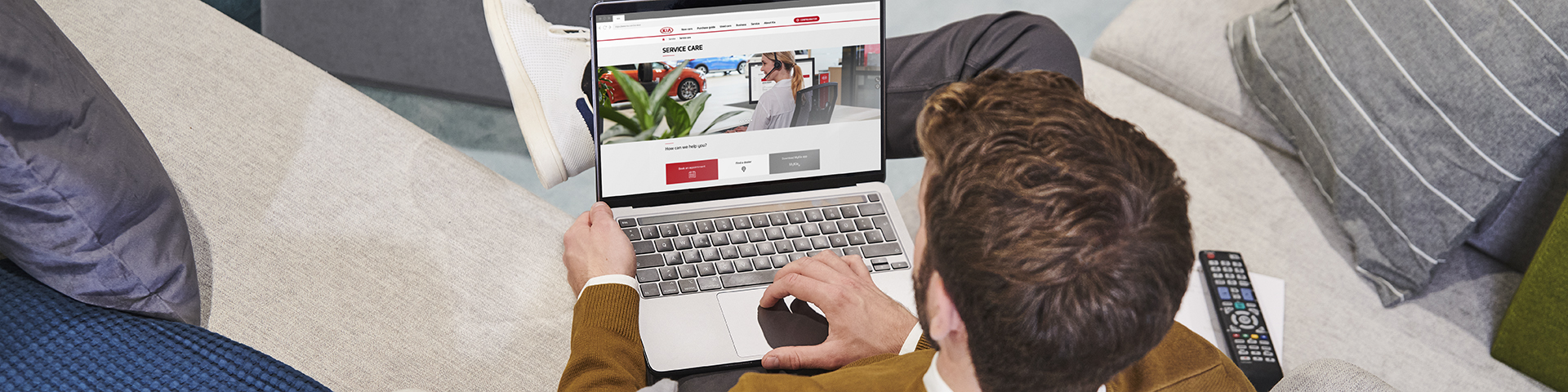 Man is holding a smartphone with the MyKia app