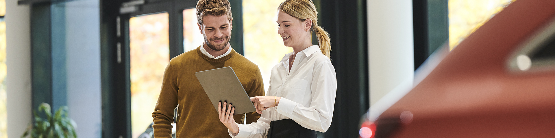 Service representative with customer inside dealership environment 