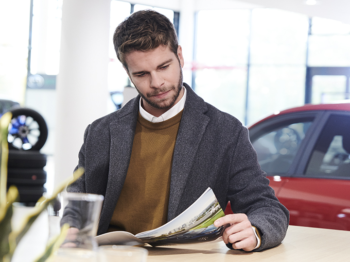Woman is reading a brochure while she is waiting 