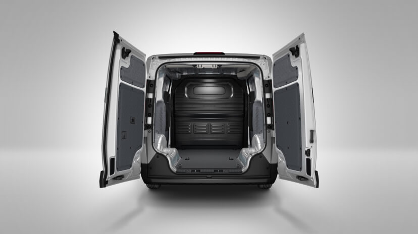 Rear cargo view of the Kia PV5 Cargo with both swing doors open, showing the full loading bay in a studio setting